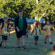 Campers at Camp Tuku proceed to the gathering area for morning mindfulness.