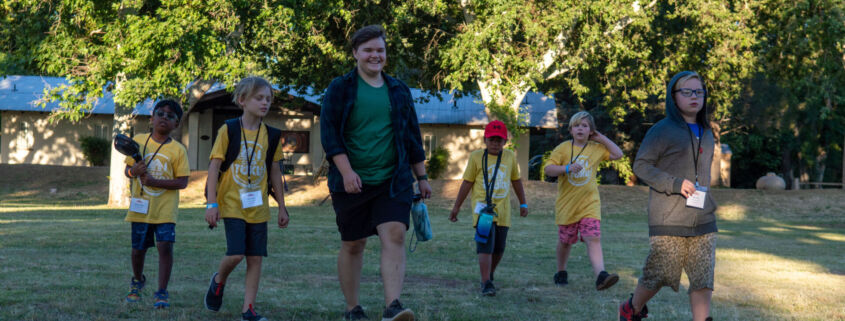 Campers at Camp Tuku proceed to the gathering area for morning mindfulness.