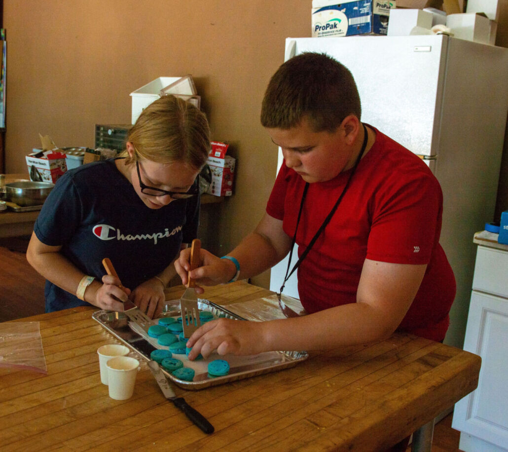 camp tuku campers make macarons in cooking class.